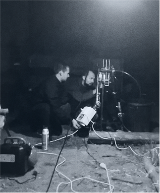 Two HyPrSpace founding members working at night on a small-scale propulsion test rig, surrounded by cables and dim lighting. A glimpse of R&D in action.